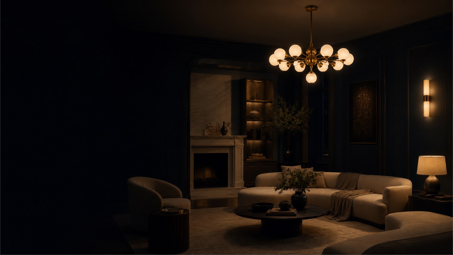 Sculptural brass chandelier glowing in a midnight navy living room