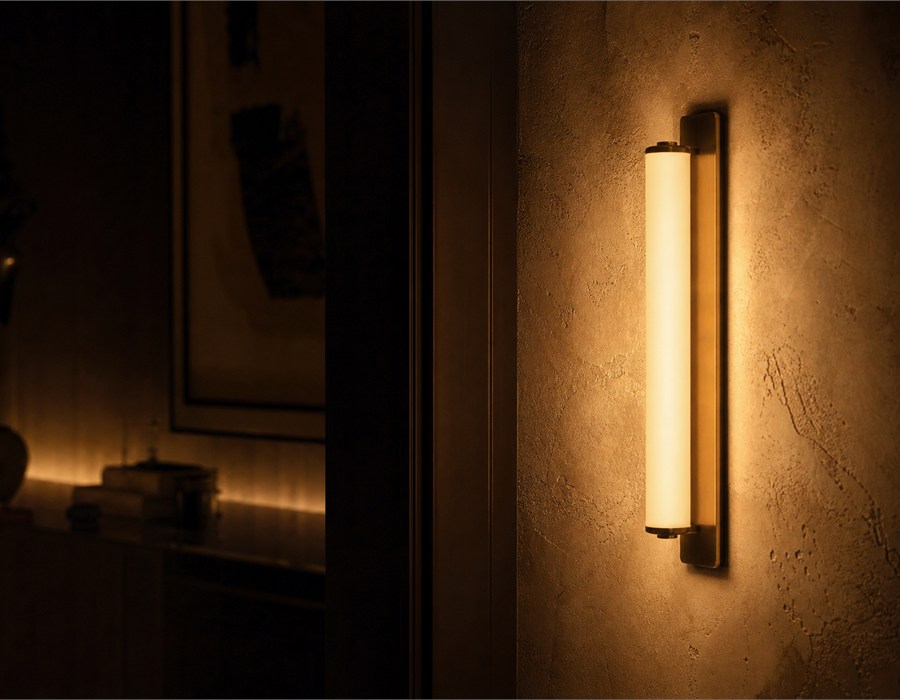 Wall light casting a candle warm 2200K glow