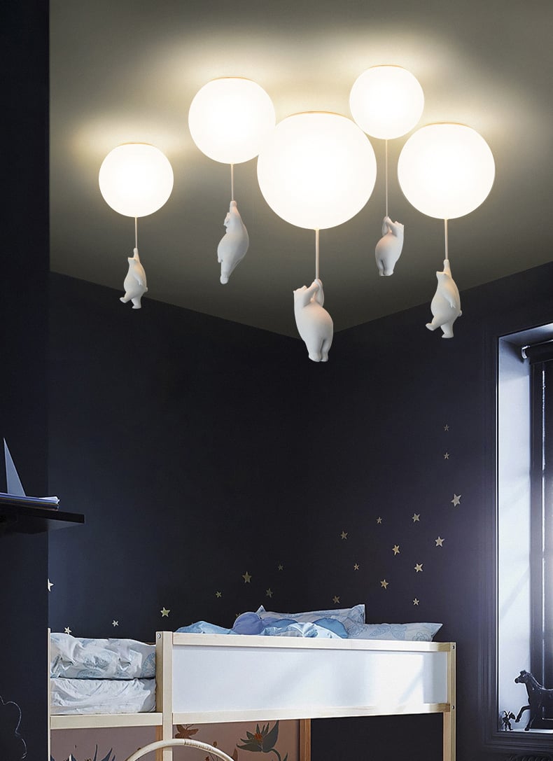 Three sculptural bears suspended from glass globes
