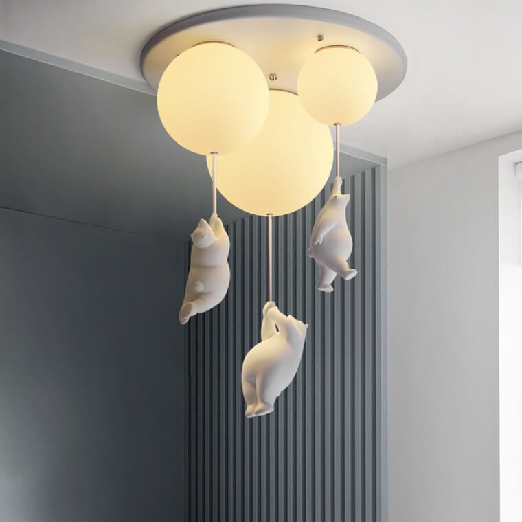 Three glass globes with suspended bear figures