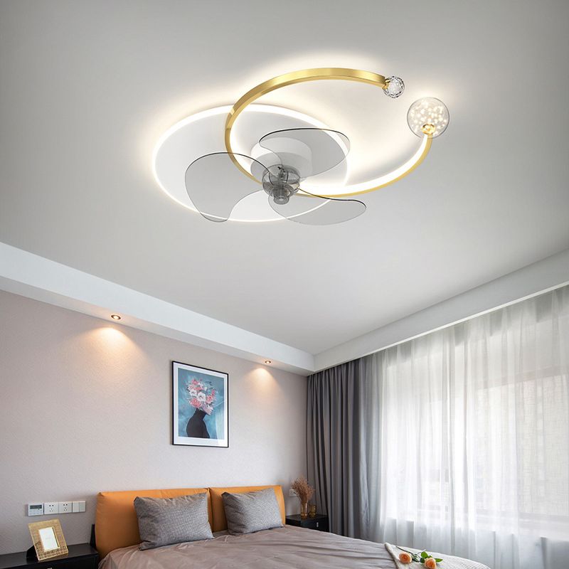 Gold-trim Madina fan light illuminated above a bedroom