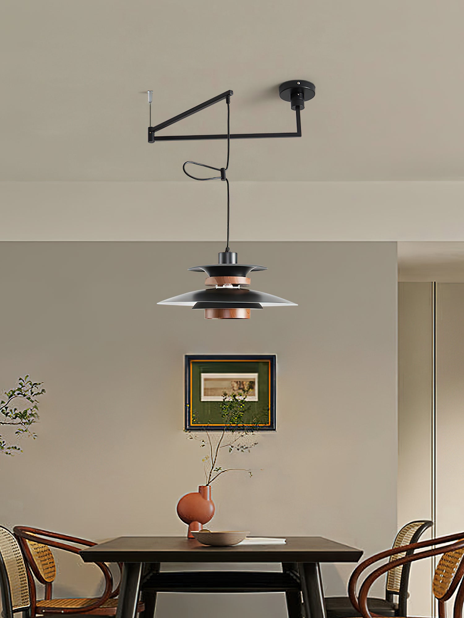 Black Mercero pendant and offset ceiling arm above furniture