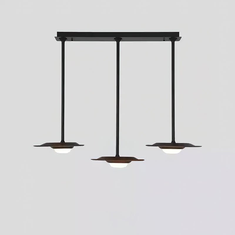 Three dark wood-tone pendant heads on black rods from a straight canopy, with the centre head hanging lower