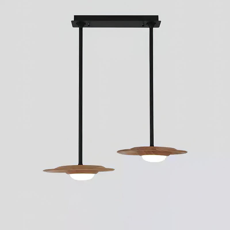 Two light wood-grain pendant heads at staggered heights on black rods from one straight black canopy