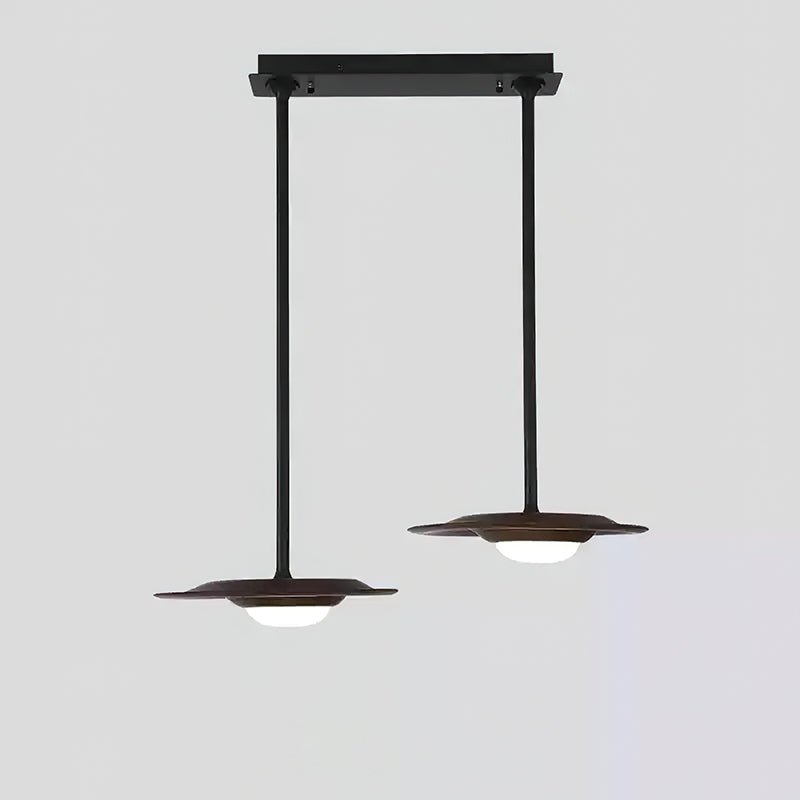 Two dark wood-tone pendant heads with white dome diffusers, staggered black rods and a shared straight canopy