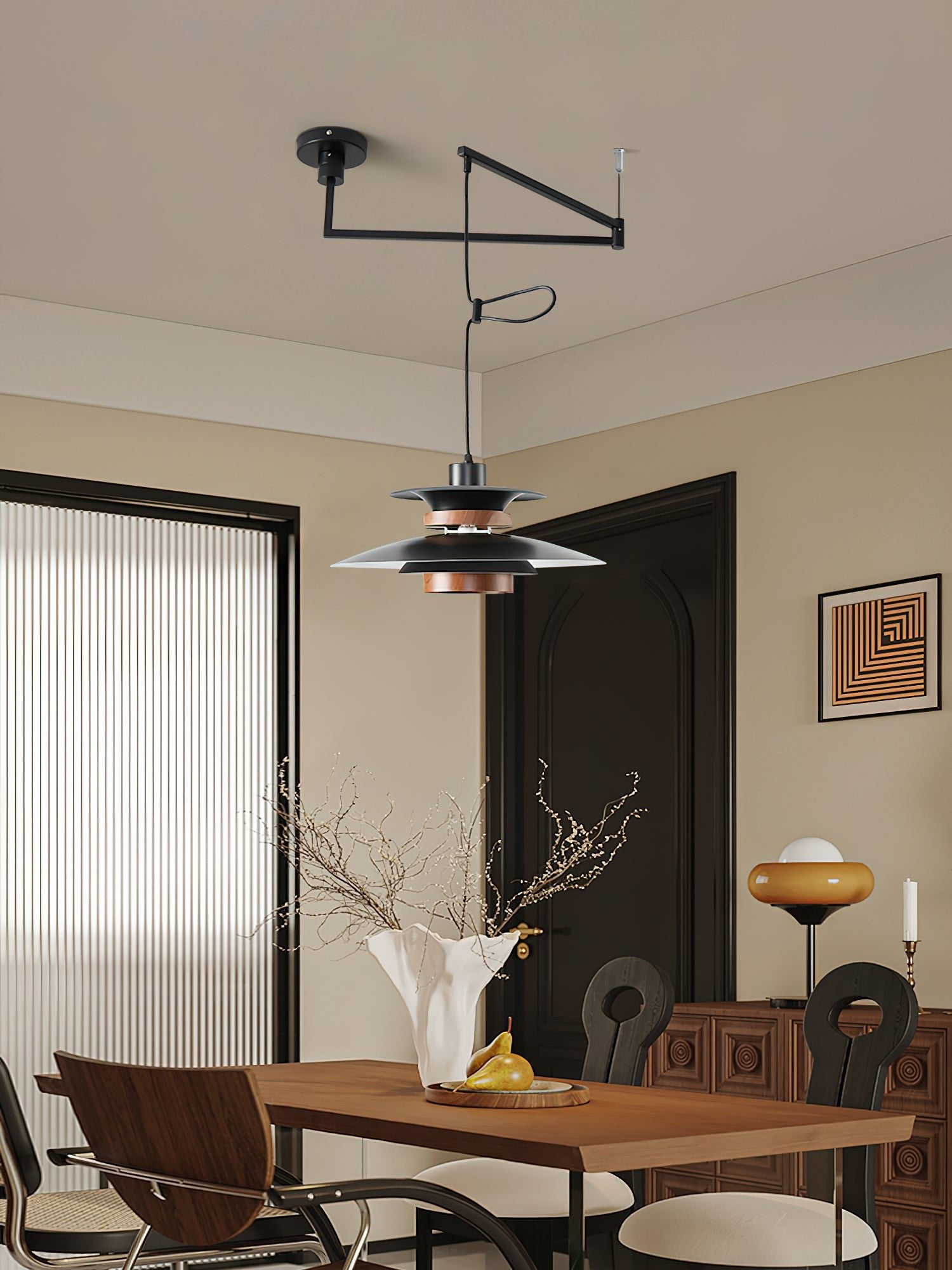 Mercero black offset-arm pendant in a dining area