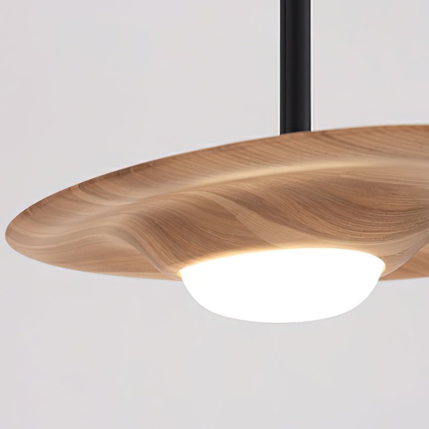 Detail of a light wood-grain shade with curved overhanging rim, glowing white dome and black rod entering above