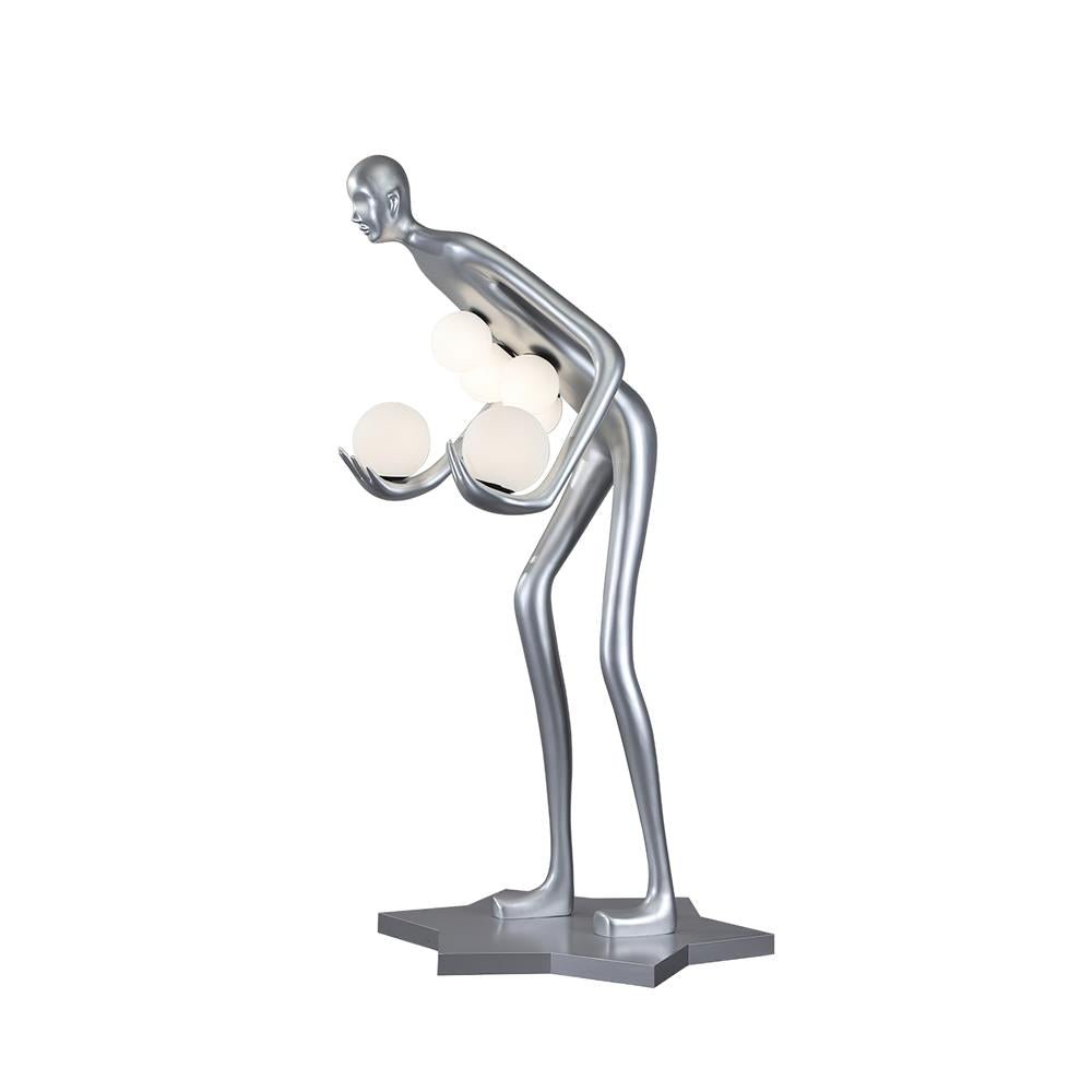Side view of a silver human-figure lamp holding white globes on a star-shaped platform