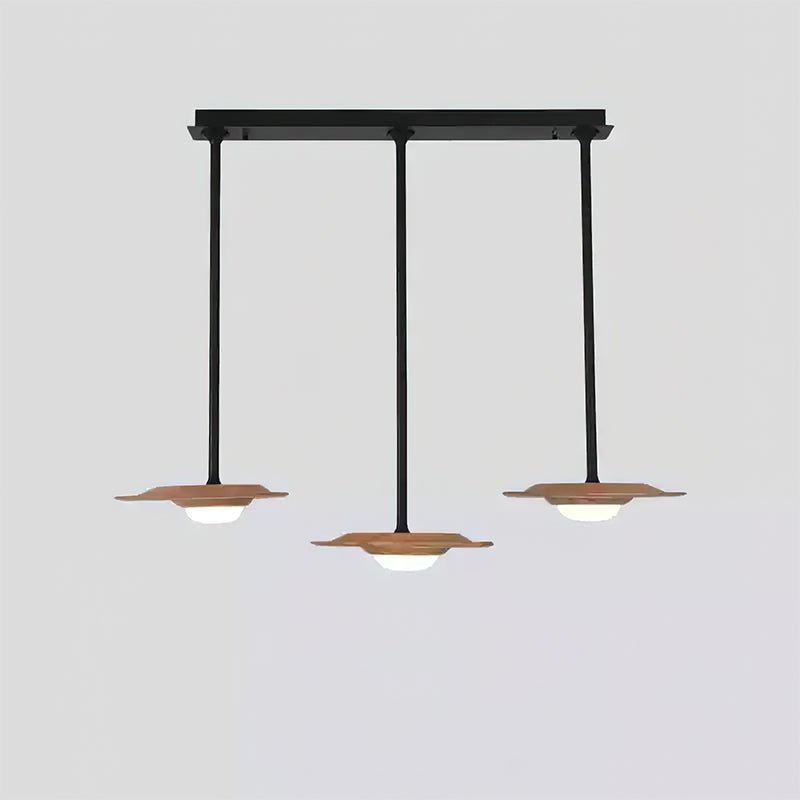 Three light wood-grain heads on a straight black canopy, with white diffusers and a lower centre pendant