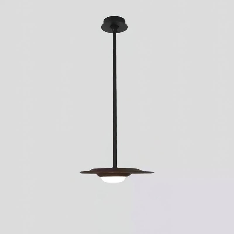 Single dark wood-tone disc pendant with white diffuser, long black rod and round black canopy against grey