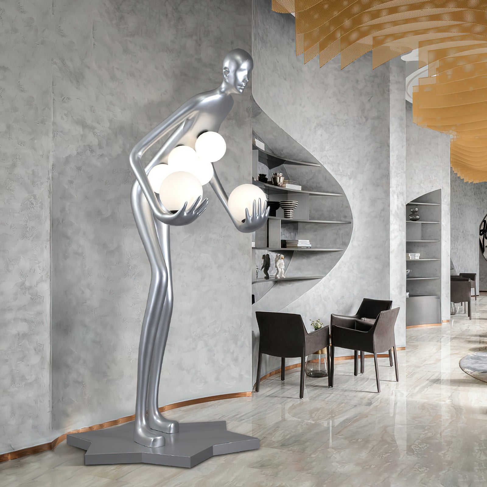 Side view of a silver figure lamp with glowing globes beside gray arched shelves and dark chairs