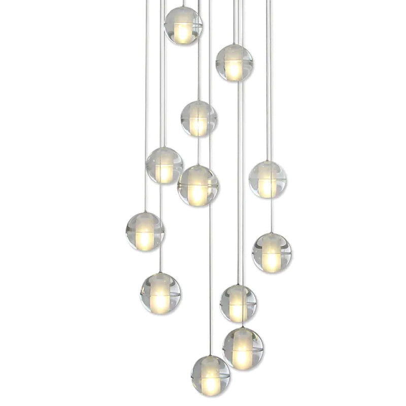 Close-up of illuminated globe-shaped shades at staggered heights
