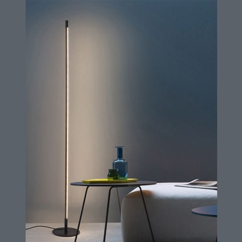 Edge linear lamp illuminating a blue-grey room corner