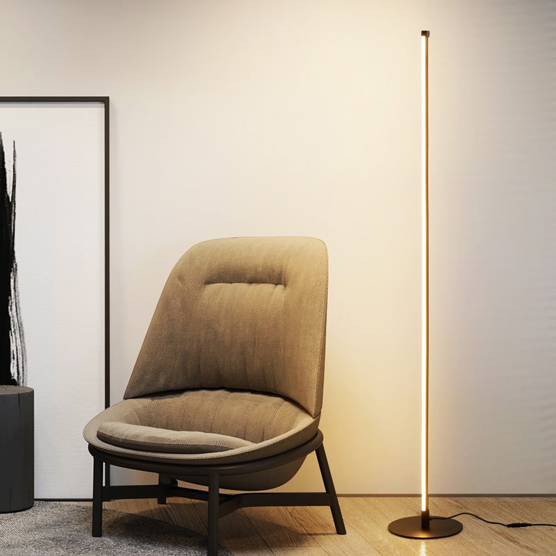 Edge floor lamp beside a tan upholstered chair