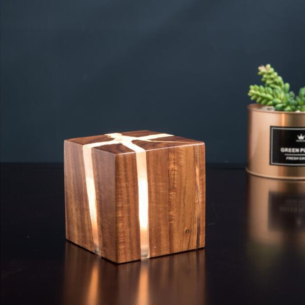 Dark wood cube-shaped accent lamp with illuminated fissures