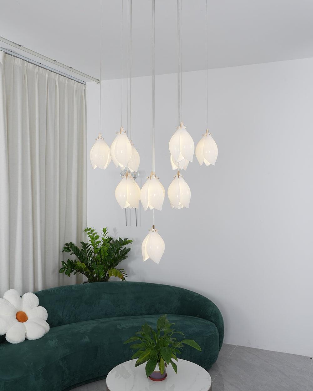 Ten glowing white flower buds above a green curved sofa and white coffee table