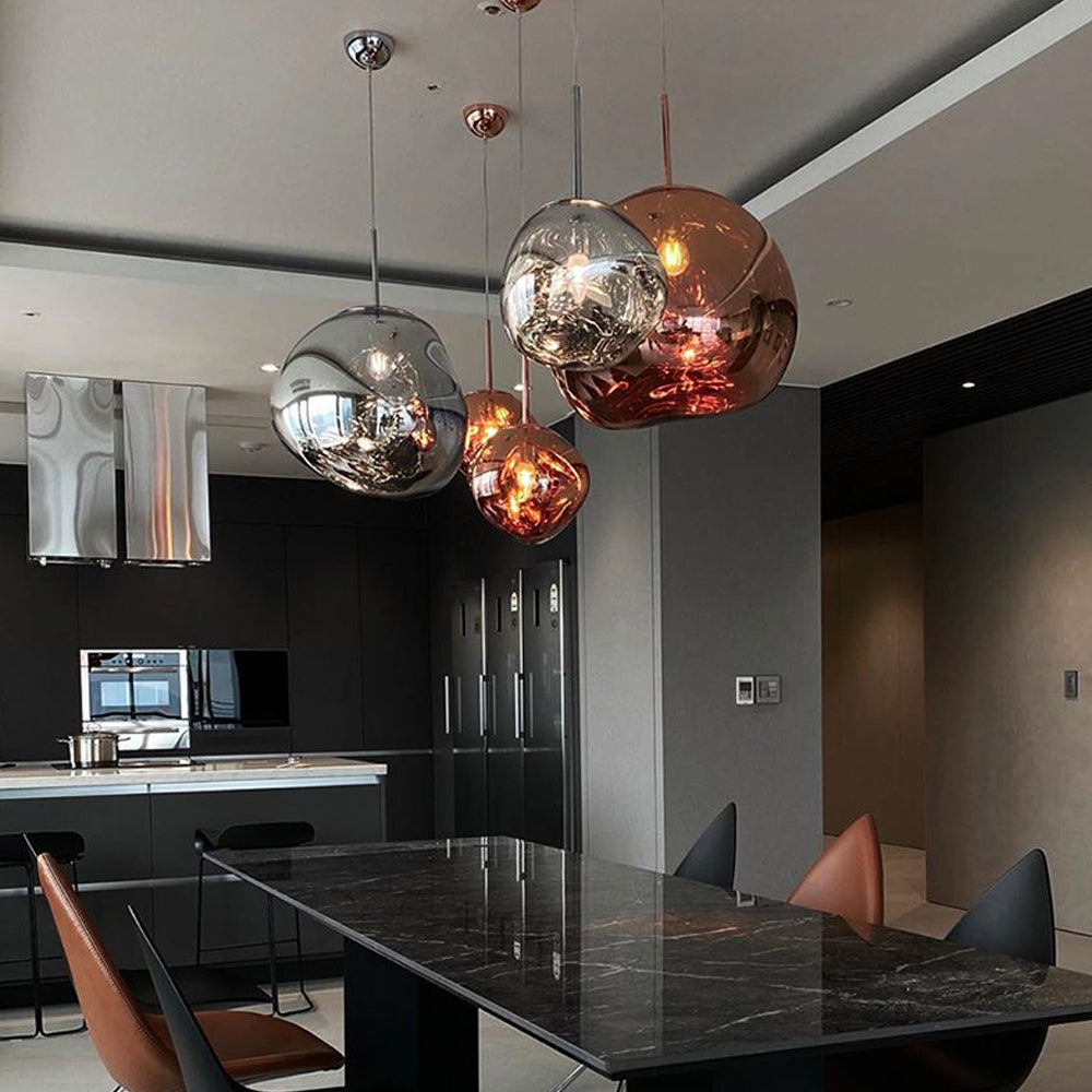 Mixed Rose Gold and Silver pendants on separate ceiling plates above a dark rectangular dining table