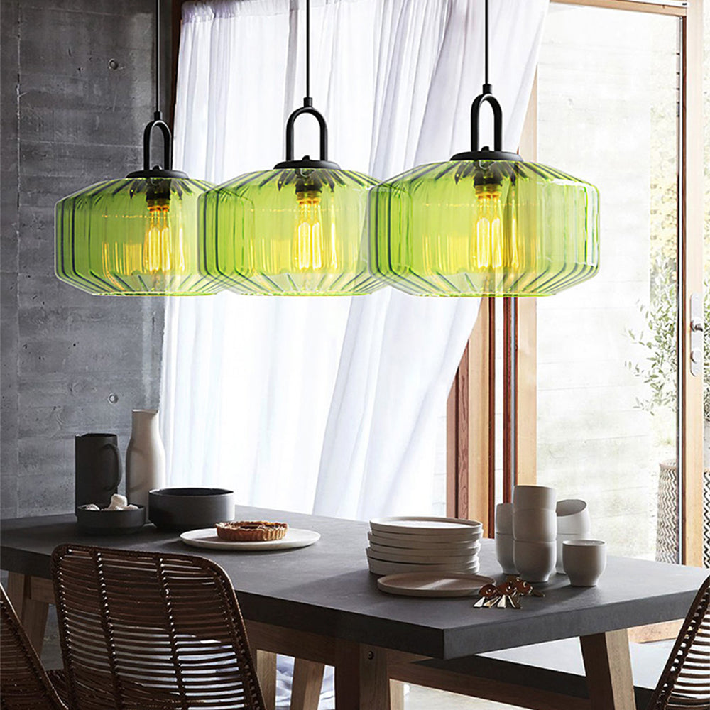 Three green glass pendants over a dining table