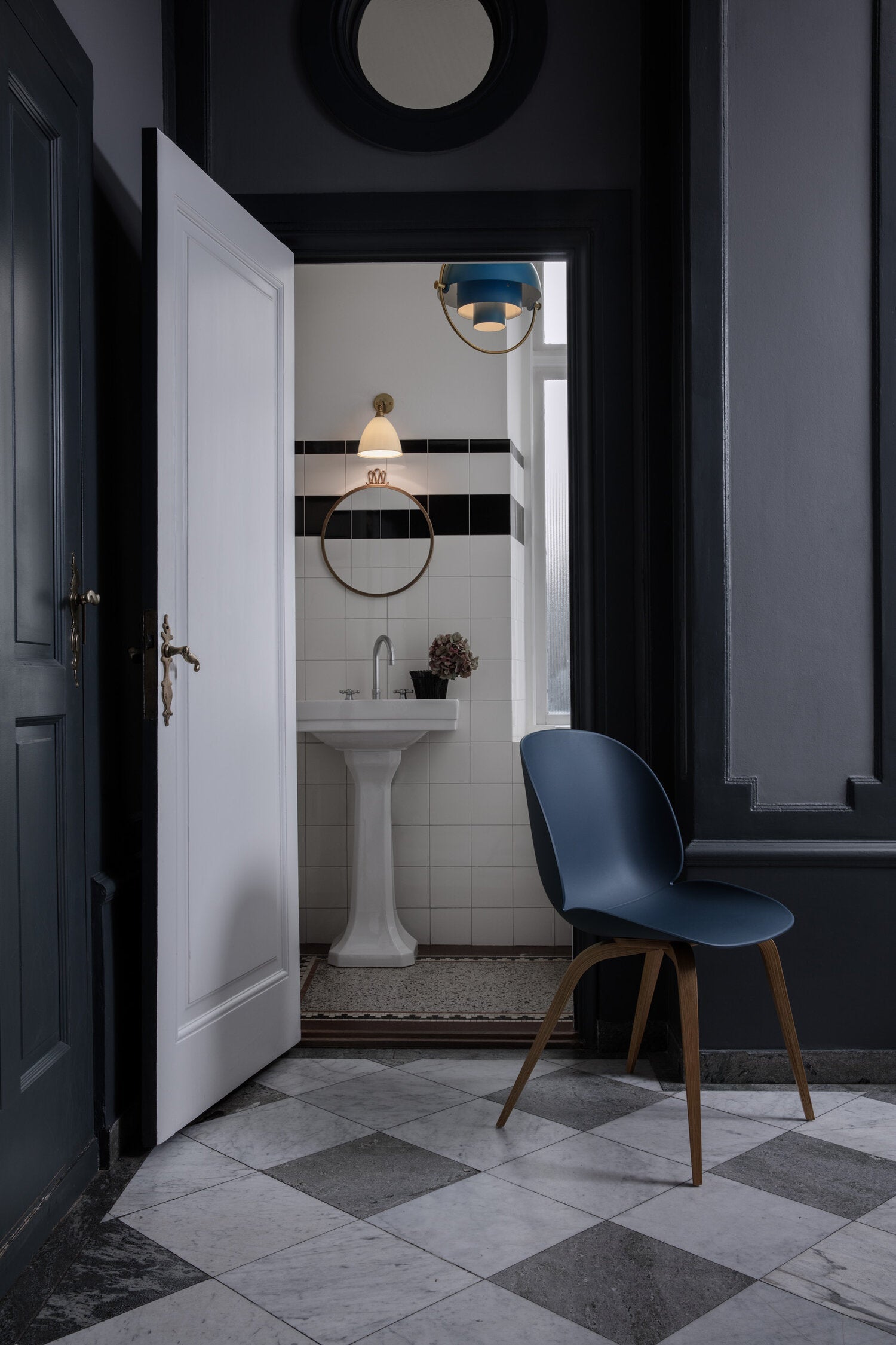 Ring pendant visible through a doorway leading toward a washbasin.