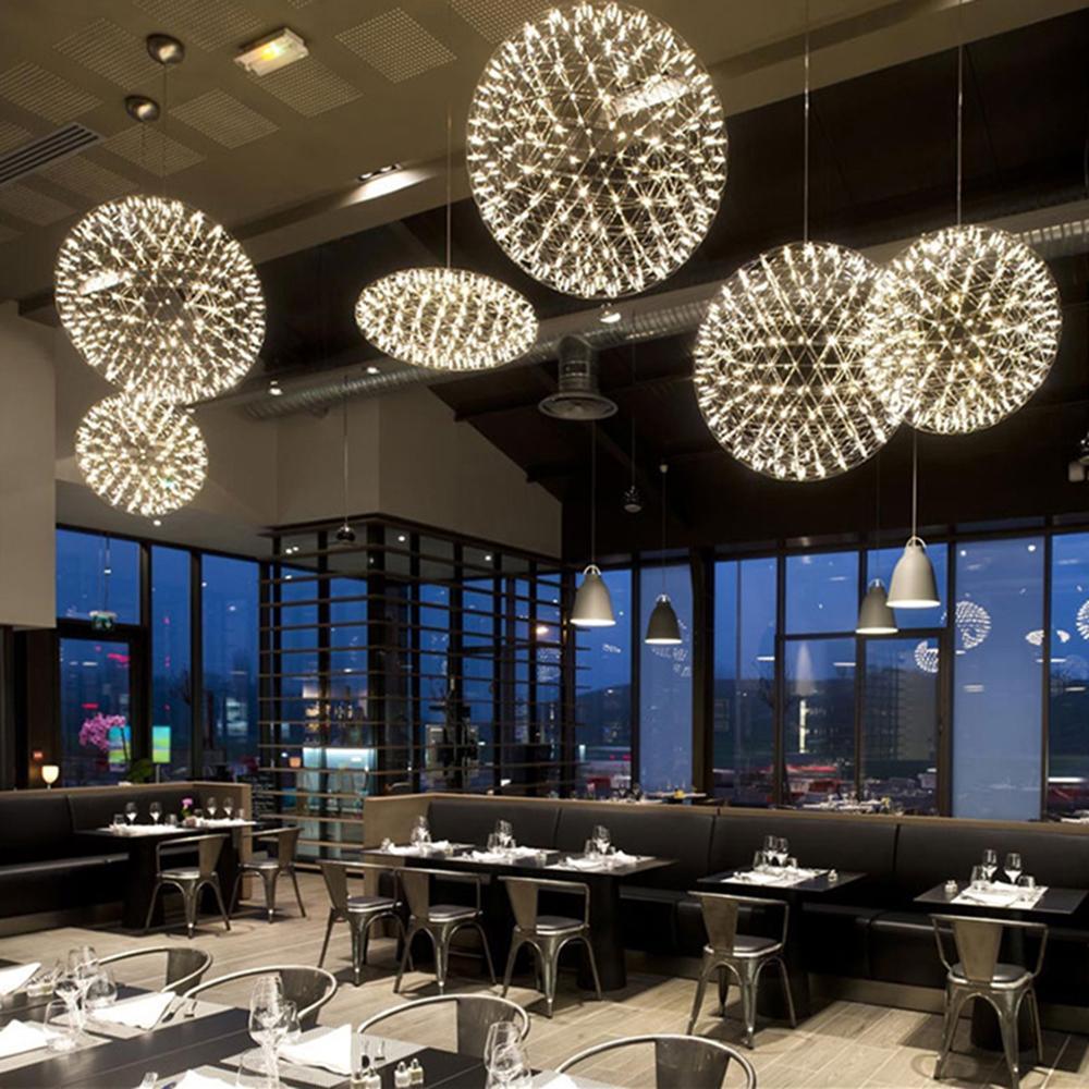 Dining-area lighting display with open globes and a flattened illuminated ring