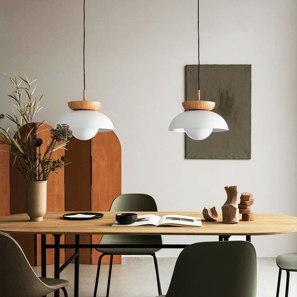 Two white wood-topped pendants in a dining setting