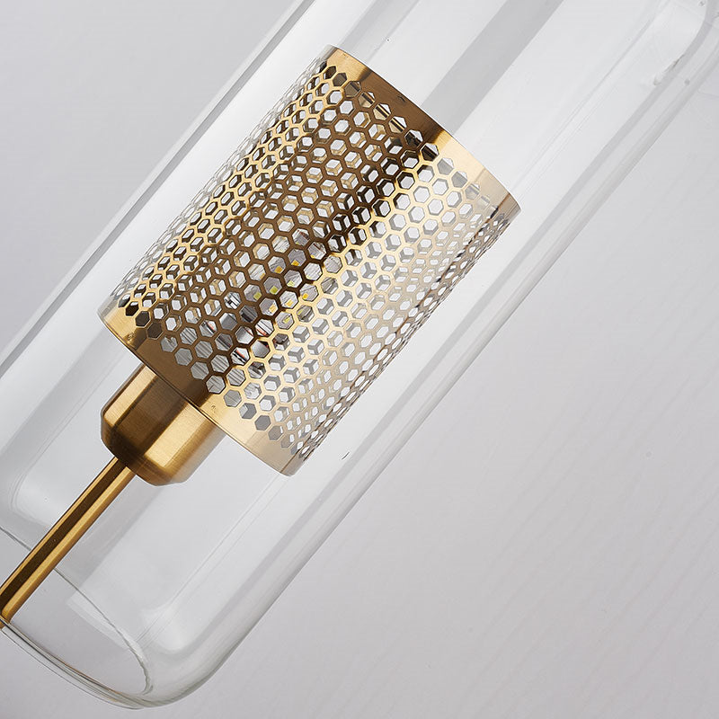 Closeup of clear rounded capsule enclosing gold-tone honeycomb cylinder with visible socket collar and central rod