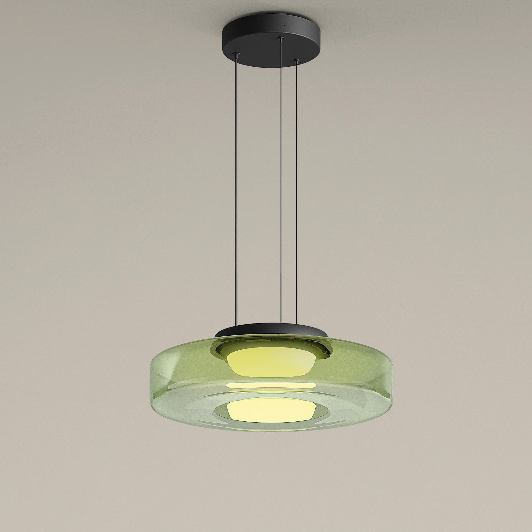 Green single-tier glass drum pendant with illuminated central diffuser and dark ceiling canopy