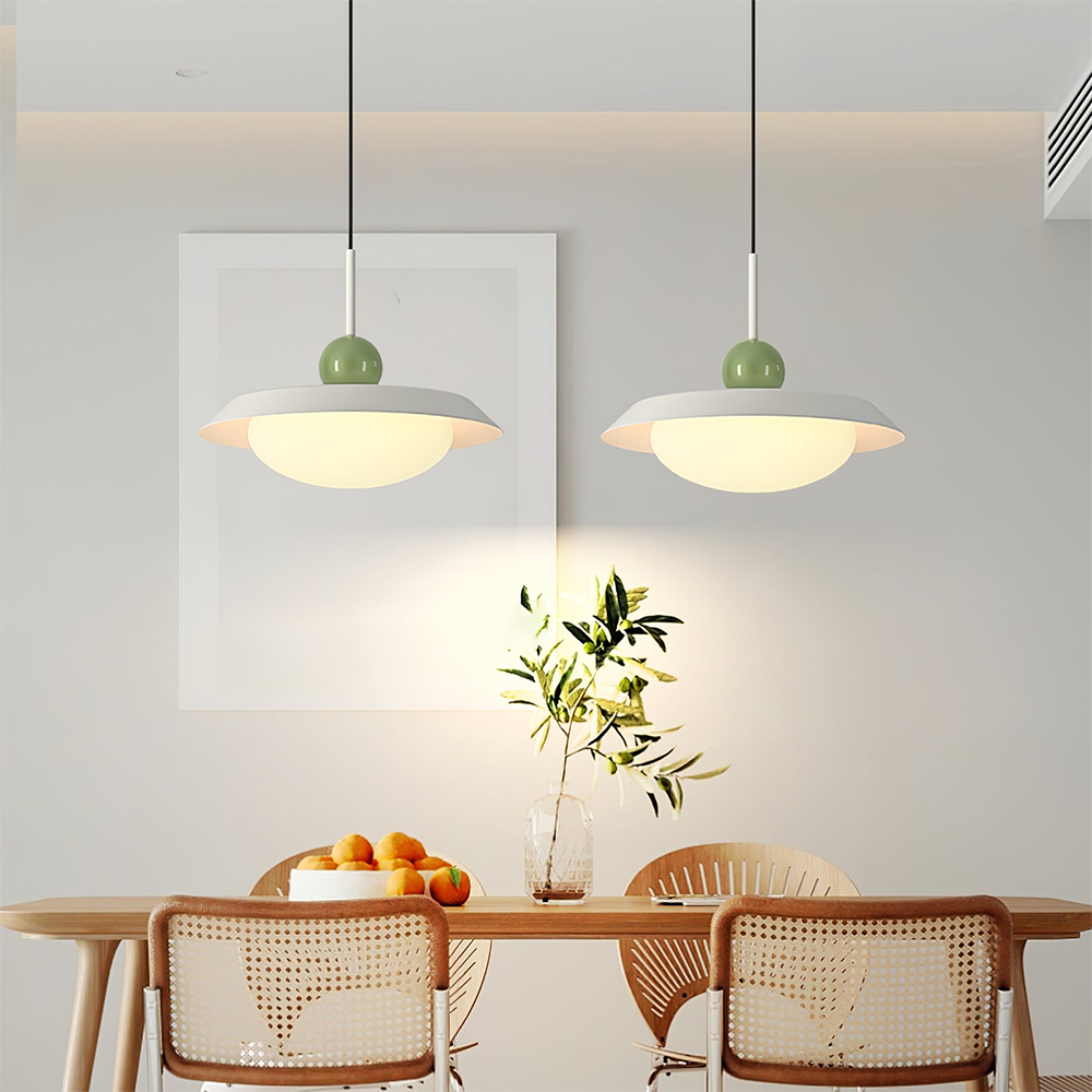 Two separate Morandi white-shade pendants with green spheres above a long dining table