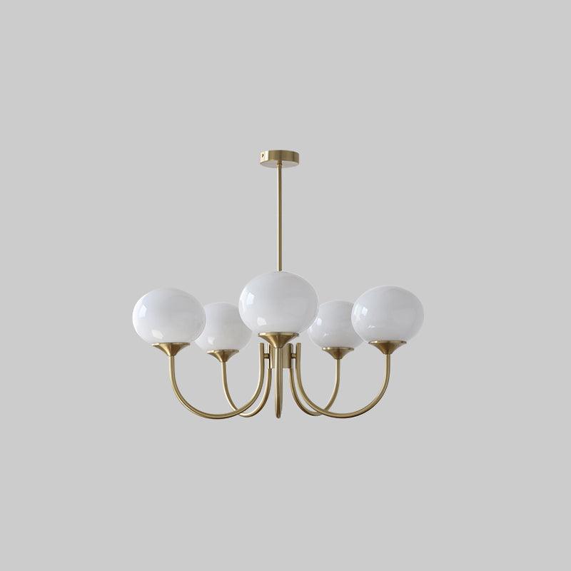 Five white glass globe chandelier with gold-tone curved arms and round canopy on a plain background