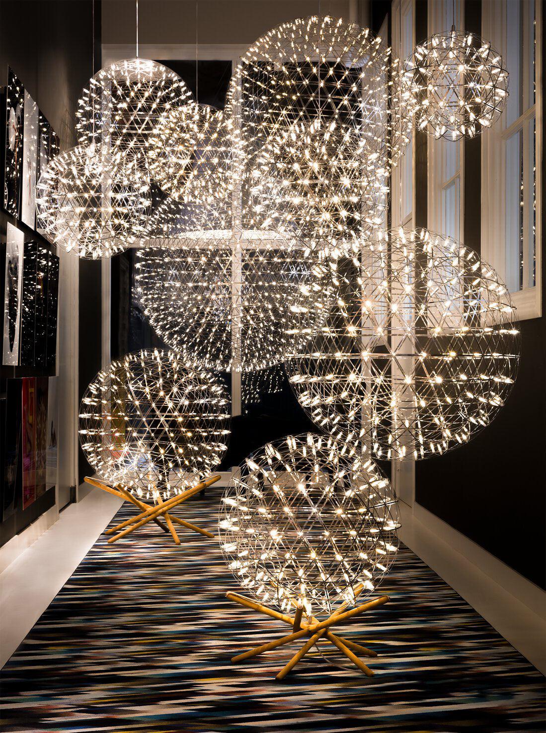 Corridor display of hanging globes and two spheres on wood cross stands