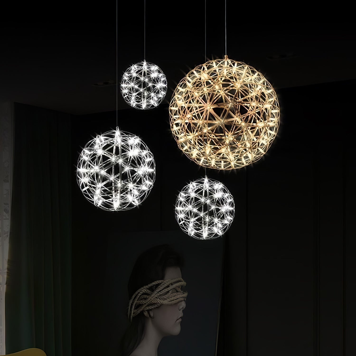 Four lit lattice globes at staggered heights in front of a large portrait