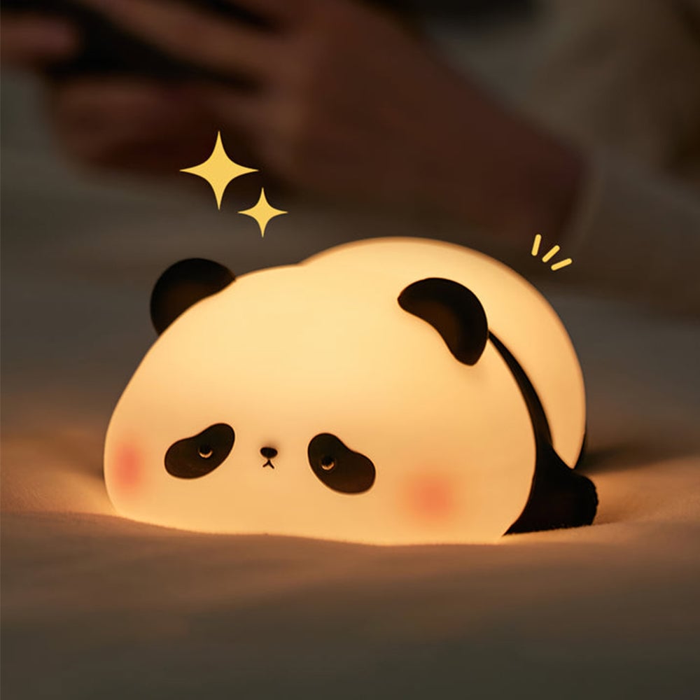 Glowing panda with pink cheeks on pale fabric beside added gold star graphics
