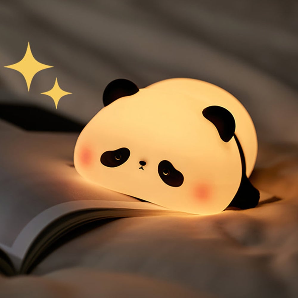 Glowing panda partly resting on an open book on a soft surface