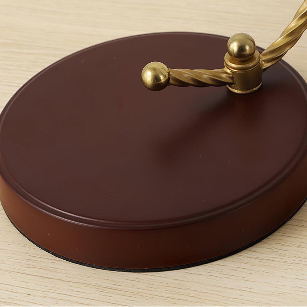 Close brown-red circular lamp base with gold-tone twisted crossbar, ball ends and stem junction
