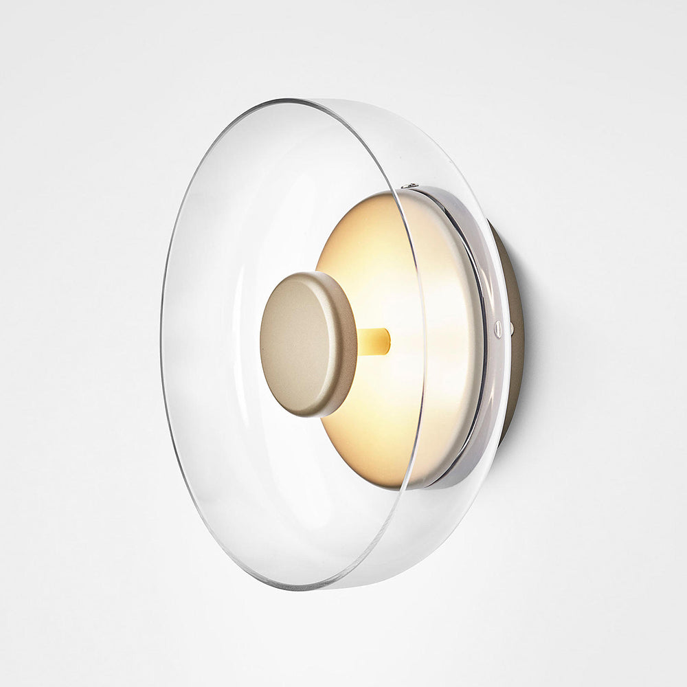 Oblique close view of clear glass bowl shade, round centre cap and gold-tone rear plate