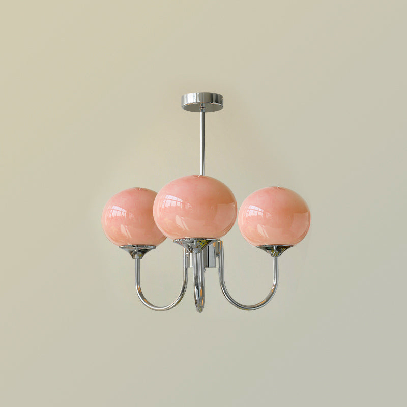 Three pink glass globes on chrome-tone curved arms beneath a matching round canopy