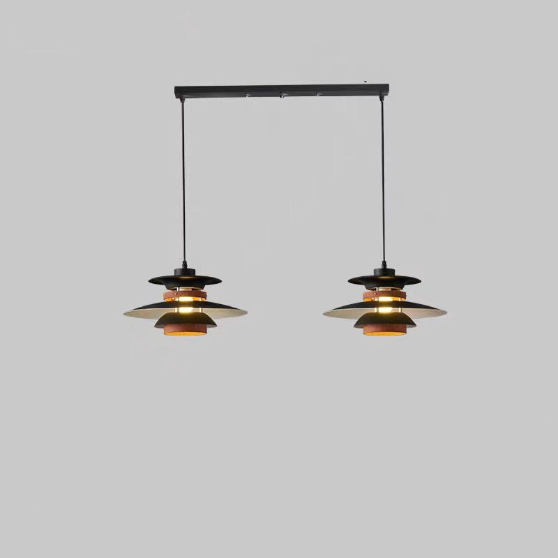 Two black Morandi layered pendant heads on cords beneath a long rectangular black canopy against grey background