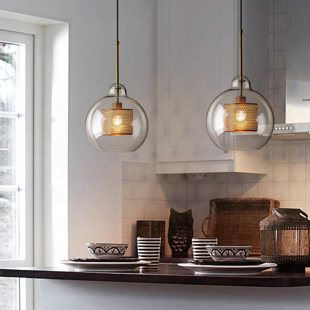 Two rounded glass shades above a dark counter
