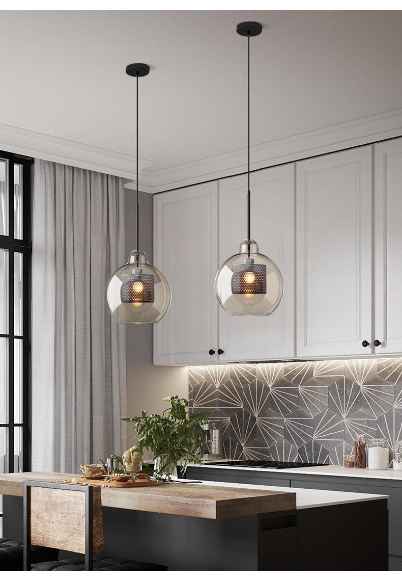 Pair of rounded glass shades over an island