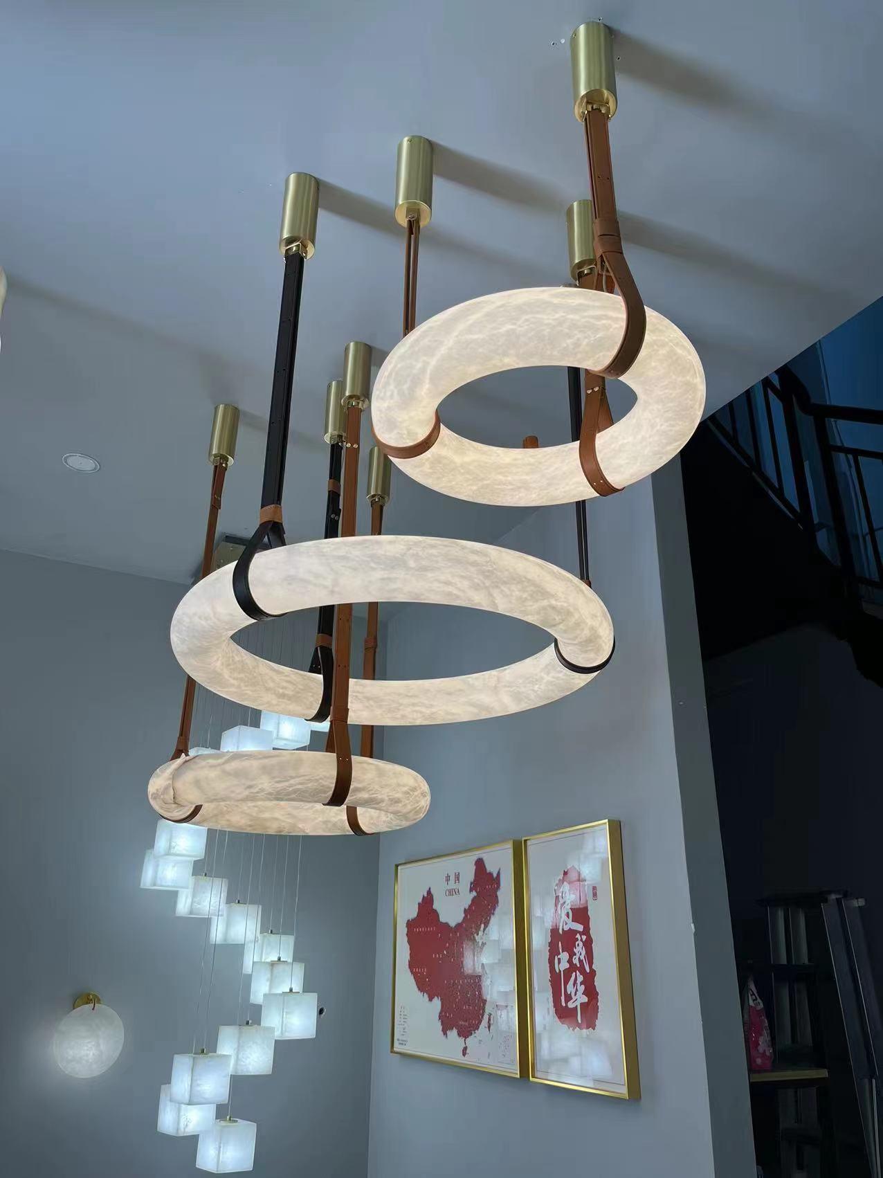 Upward view of a group of horizontal rings, straps and ceiling mounts.