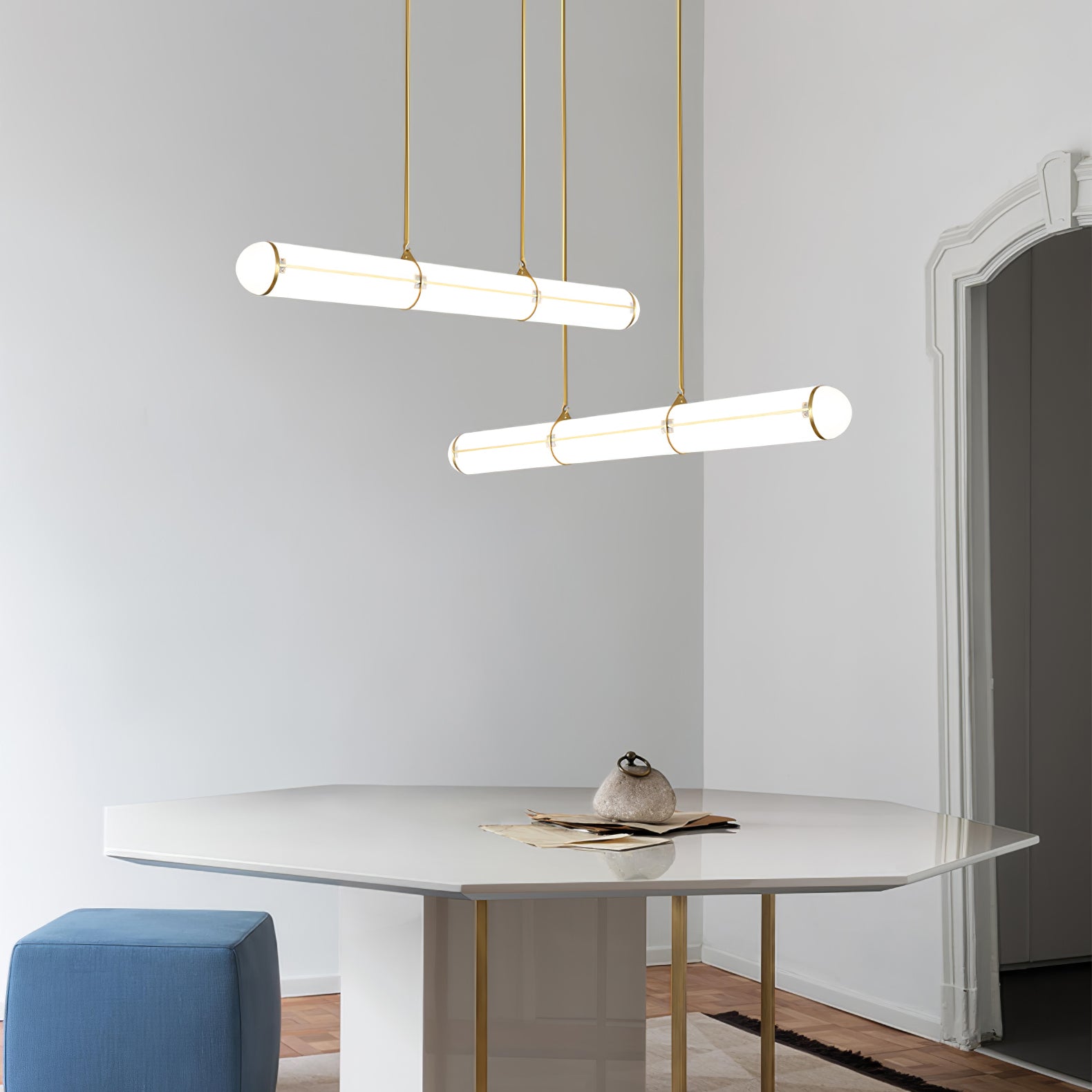 Two cylindrical pendants arranged above a round table