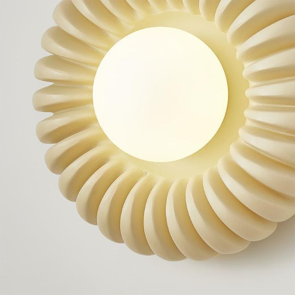 Bright opaque White centre surrounded by curved beige radial flutes in close-up