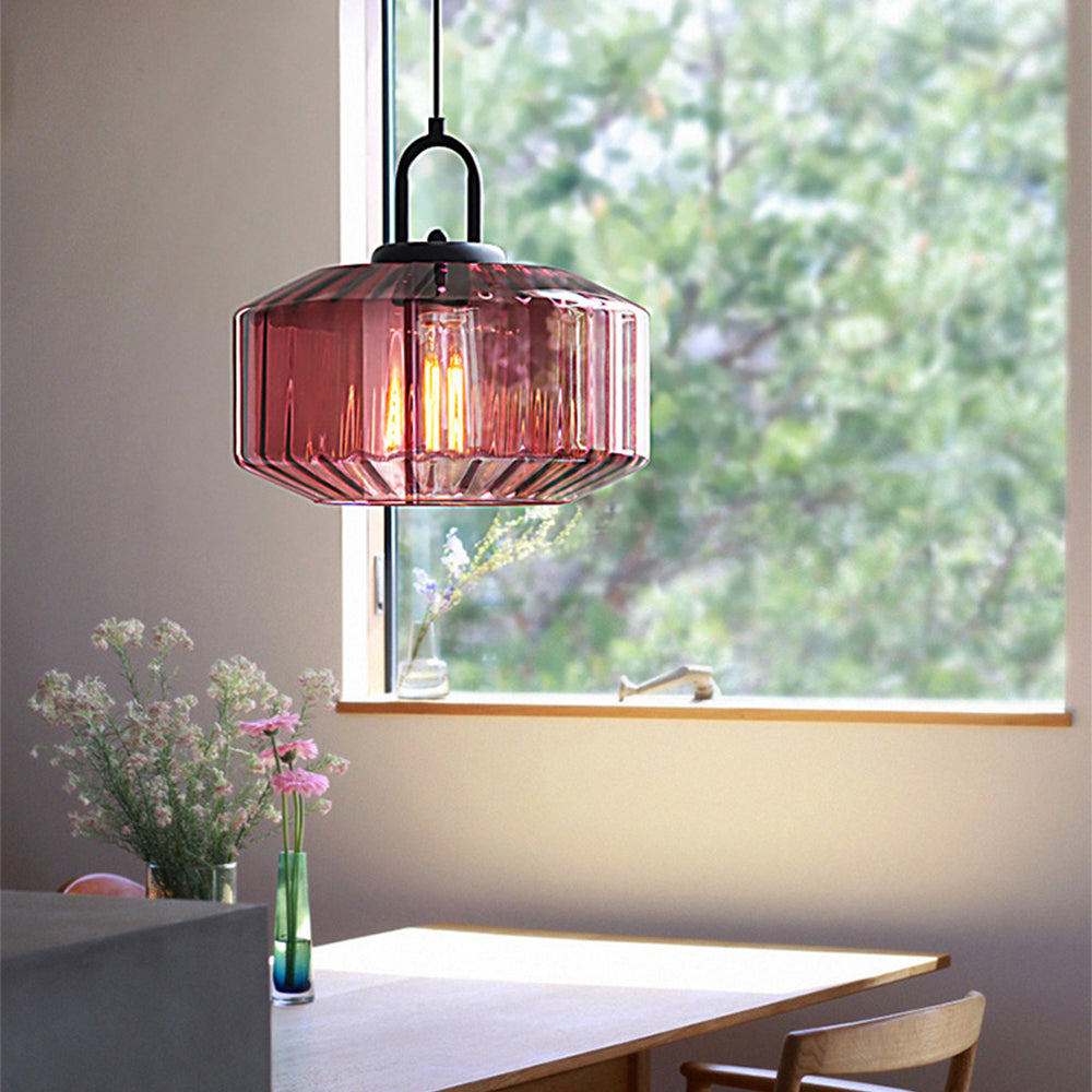 Purple glass pendant beside a window