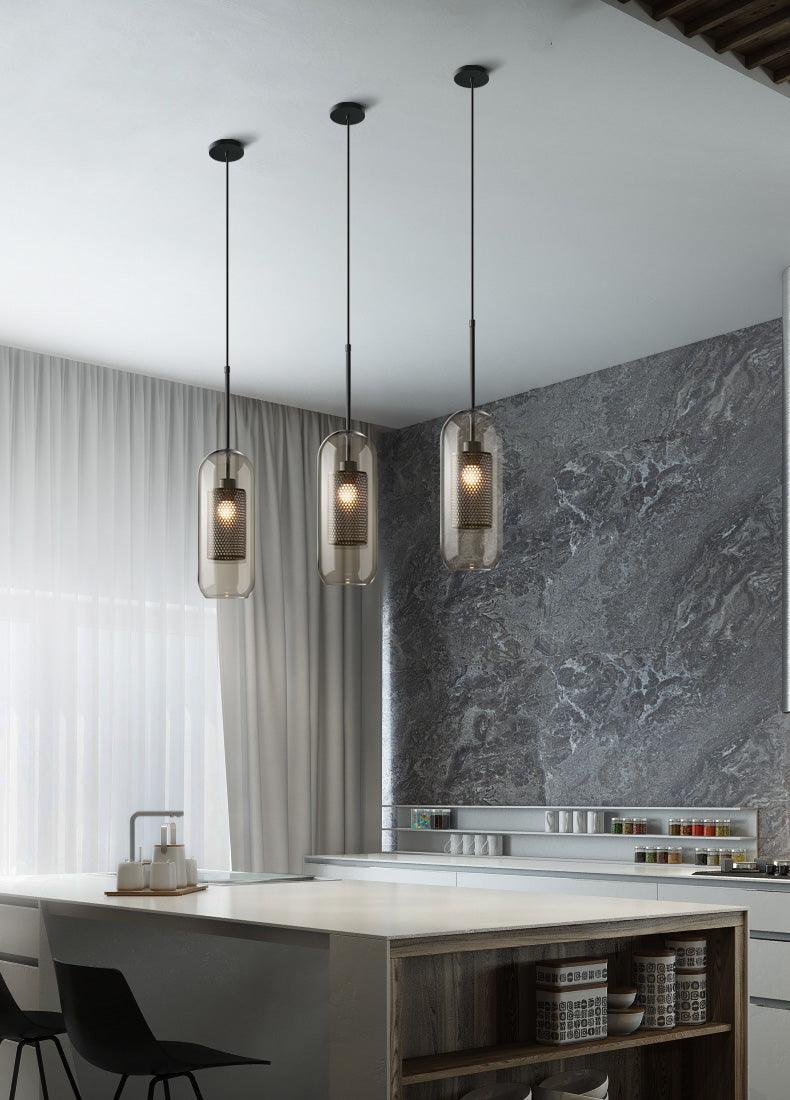 Three Capsule pendants above a kitchen island