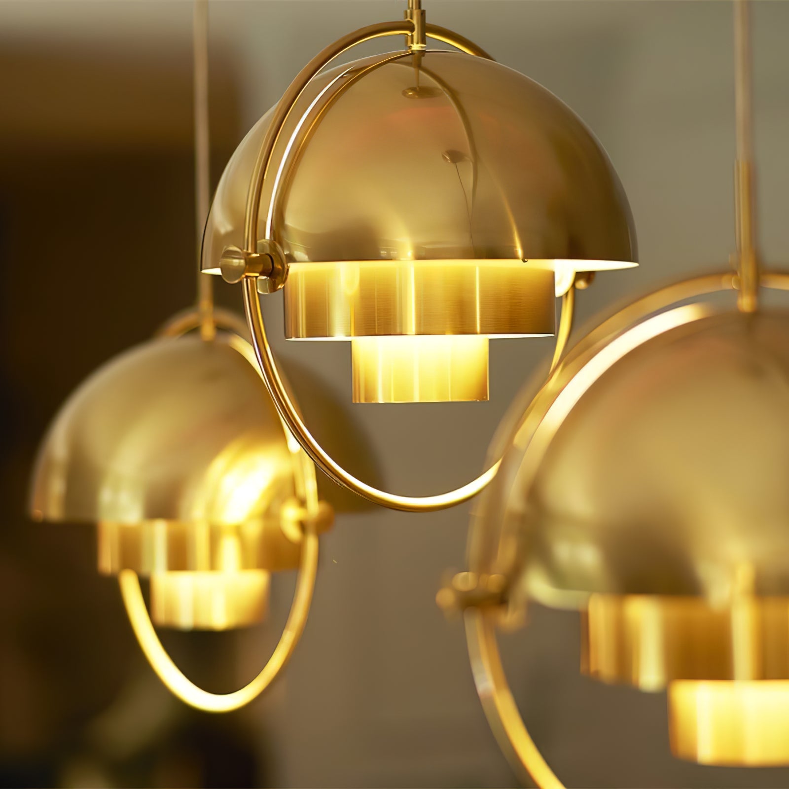 Close view of glowing gold-toned dome shades inside circular frames.
