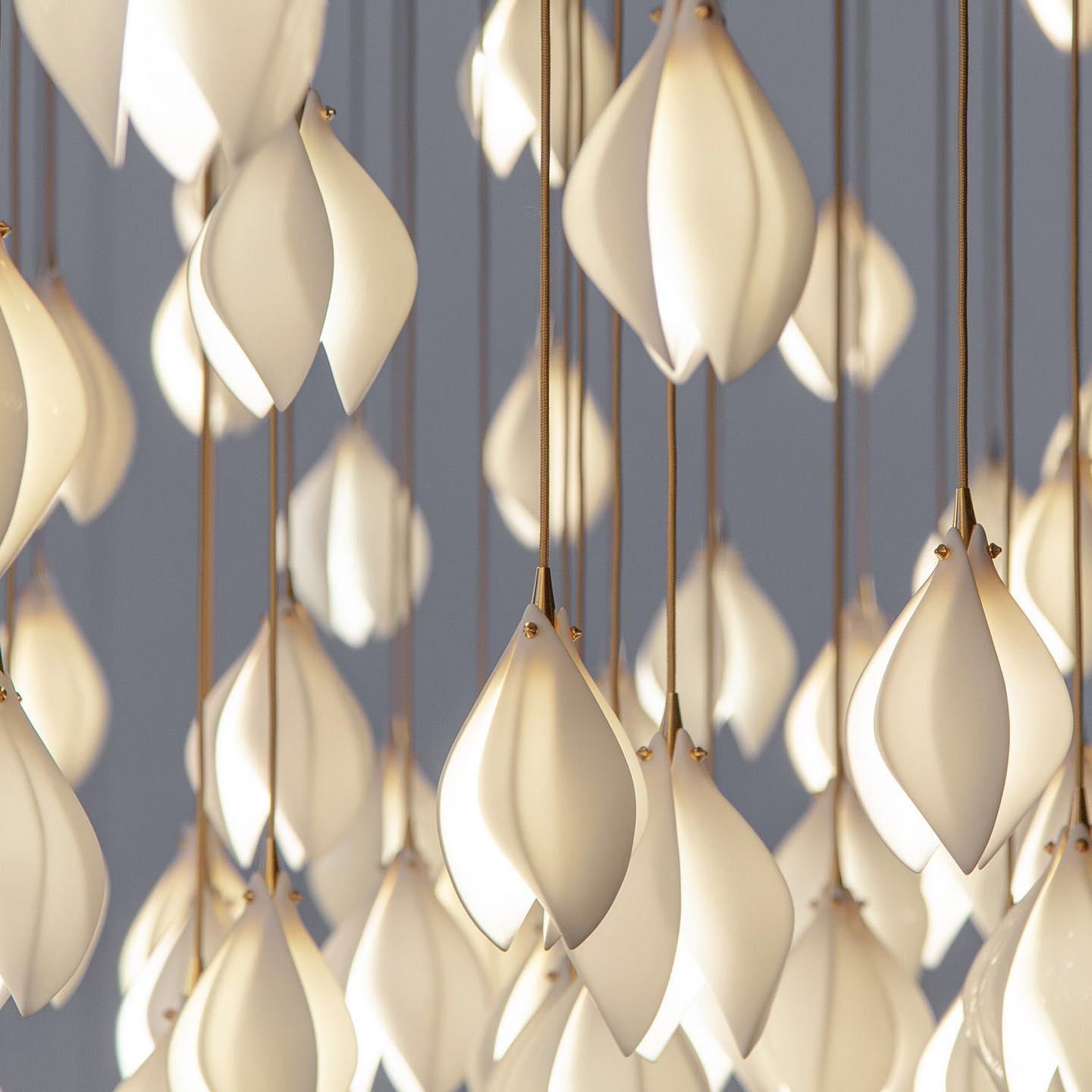 Close white petal surfaces with gold-tone fittings and braided-looking cords