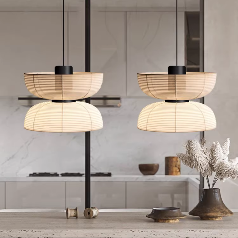 Two broad upper-bowl and lower-dome pendants above a kitchen island