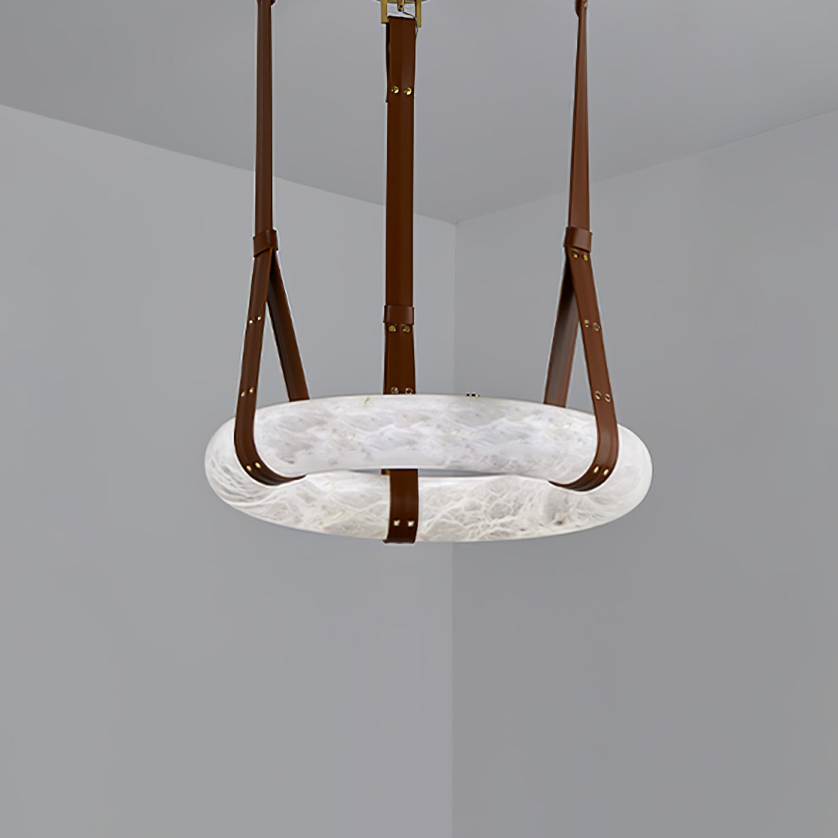 Alabaster ring viewed from below with brown straps meeting its rim.