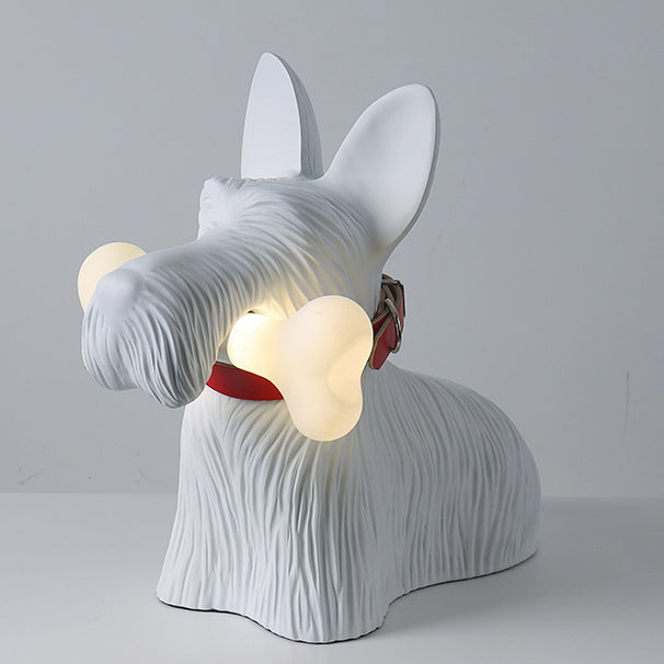 Three-quarter view of the white dog lamp with glowing bone, long muzzle and upright ears on a pale surface