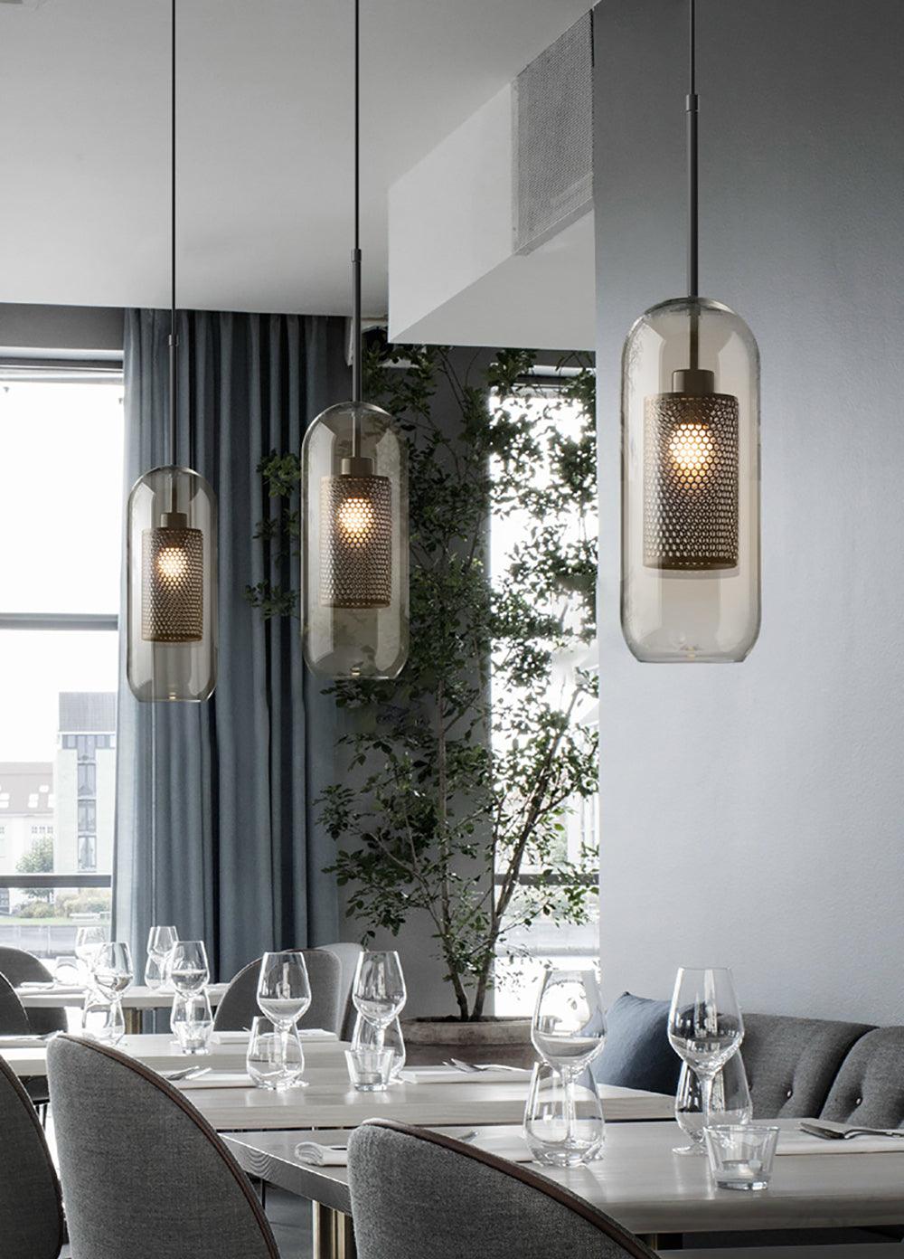 Tall Capsule pendants over a set dining table